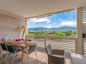 a dining room with a table and chairs and a large window at Apartment Résidence Cita di Sali-11 by Interhome in Porto-Vecchio