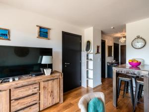 a living room with a large television and a table at Apartment Résidence Cita di Sali-11 by Interhome in Porto-Vecchio
