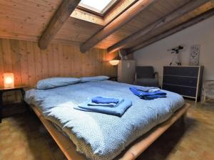 a bedroom with a large bed with blue towels on it at Apartment Nido dello Stelvio by Interhome in Pezzo