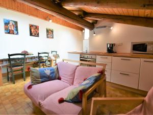 a living room with a couch and a kitchen at Apartment Nido dello Stelvio by Interhome in Pezzo