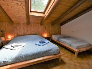 a bedroom with two beds in a wooden cabin at Apartment Nido dello Stelvio by Interhome in Pezzo