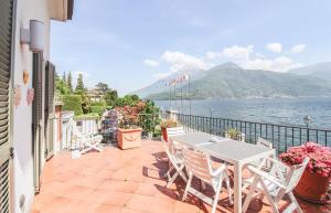 a patio with a table and chairs and the water at Appartamento La Perla del Lago in Dongo