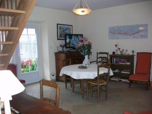 a dining room with a table with a vase of flowers on it at Holiday home Gîte des Hautes Côtes de Beaune in Magny-lès-Villers