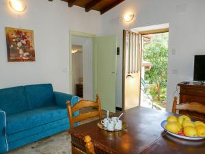 a living room with a blue couch and a table at Holiday Home Ca'Mea by Interhome in Chiusanico