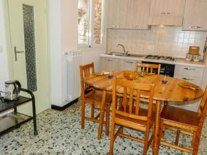 a kitchen with a wooden table and some chairs at Holiday Home Ca'Mea by Interhome in Chiusanico