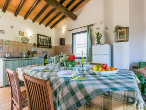 a kitchen with a table with a bowl of fruit on it at Apartment Tramontana by Interhome in Bibbona