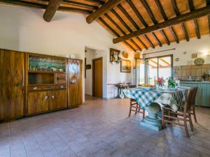 a kitchen and dining room with a table and chairs at Apartment Tramontana by Interhome in Bibbona