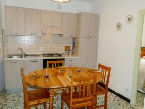 a kitchen with a wooden table and some chairs at Holiday Home Ca'Mea by Interhome in Chiusanico