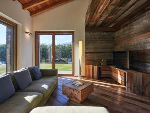 a living room with a couch and a table at Villa Woodhouse by Interhome in Colico +57 photos