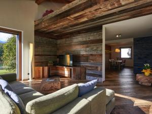 a living room with a couch and wooden walls at Villa Woodhouse by Interhome in Colico