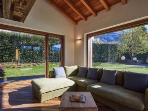 a living room with a couch and a large window at Villa Woodhouse by Interhome in Colico