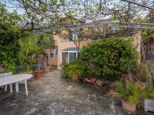 un patio con un banco blanco y algunas plantas en Holiday Home Sara by Interhome, en Alassio