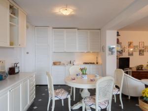 a kitchen with a table and chairs in a kitchen at Holiday Home Sara by Interhome in Alassio