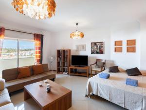 a living room with a bed and a couch at Apartment Capital 4 You by Interhome in Portimão