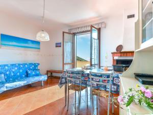 a living room with a table and chairs and a couch at Apartment Terrazza di Paolo by Interhome in Rio nellʼElba