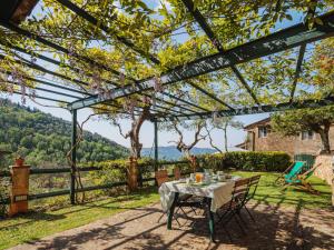 a table and chairs under a pergola with a view at Holiday Home Il Glicine by Interhome in Montemagno