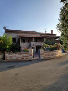 a house with flowers in front of it at Apartmani Memić 100 m do plaže, APARTMENTS MEMIĆ ONLY 100M FROM BEACH in Poreč