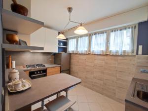Il comprend une cuisine équipée d'une table et d'une cuisinière. four supérieur dans l'établissement Apartment Nena & Vale by Interhome, à Dongo