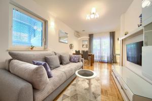 a living room with a couch and a television at Villa Punta in Punat