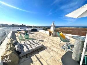 a patio with a view of the ocean on a roof at Paradise Sea Terrace in Monopoli