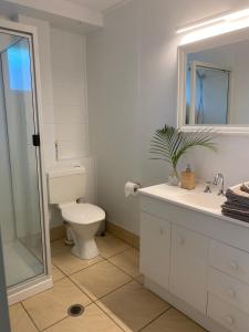 a bathroom with a toilet and a sink and a mirror at Tree Escape in Rainbow Beach