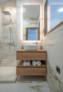 a bathroom with a sink and a mirror at Apartments Nikčević in Kotor