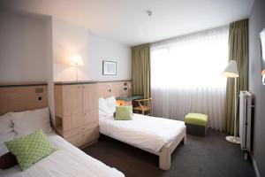 Postel nebo postele na pokoji v ubytování Hotel Van Bunnen