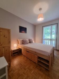 Un dormitorio con una cama grande y una ventana en L'Atelier du Temps - Hemmet, en Courmayeur