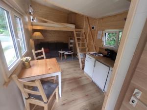 a tiny house with a kitchen and a dining room at Alpenhotel Beslhof in Ramsau