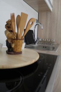 a kitchen with a table with wooden utensils at Apartment River in Klis