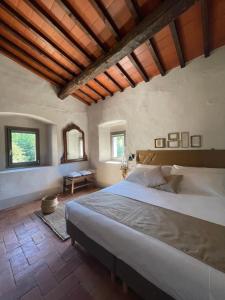a bedroom with a large bed and a wooden ceiling at Casale La Gora - B&B di charme in Figline Valdarno