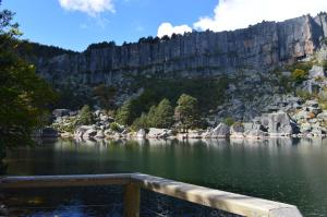 a view of a lake with a mountain in the background at Hostal Revinuesa in Vinuesa