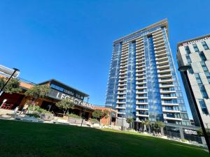 a tall building with a grass field in front of it at Umhlanga Arch Luxury in Durban