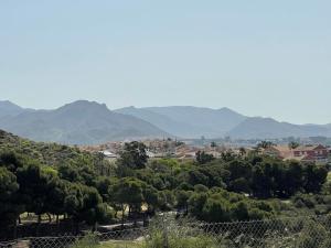 a view of a town with mountains in the background at El Alamillo ground floor apartment with sea view in Mazarrón