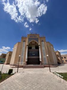 a front view of a museum with a building at Said Islom Khoja in Khiva