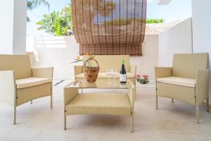 een patio met een glazen tafel en 2 stoelen bij Baia Marzamemi appartamenti Vendicari, Balata, Tonnara, Cortile del Rais in Marzamemi