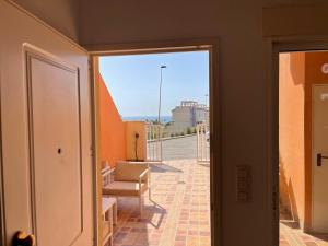 a view of a room with a chair and a window at El Alamillo ground floor apartment with sea view in Mazarrón