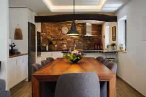 a dining room with a wooden table and chairs at Casa do Avô Horácio in Viana do Castelo