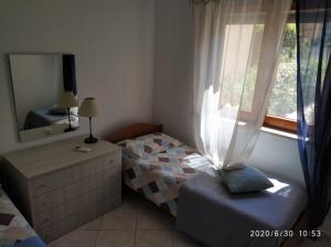 Cama o camas de una habitación en Sabbia di Marinella