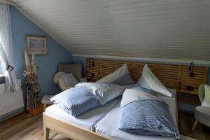 a bed with pillows on it in a room at Privatzimmer Haring in Kitzeck im Sausal