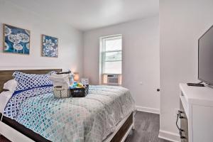 a bedroom with a bed and a flat screen tv at Cozy Philadelphia Retreat about 4 Mi to Downtown in Philadelphia