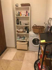 a laundry room with a washing machine and a washer at Archelaou Street Living in Athens