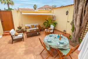 a patio with a table and chairs and a couch at Fidalsa Coastal Soul in Torrevieja