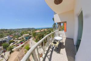 a balcony with a table and a view of a city at Villa Los Corales in Sayulita