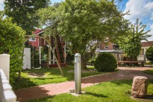 a park with a tree and a playground at Haus Strandgang, Whg 8 in Kellenhusen