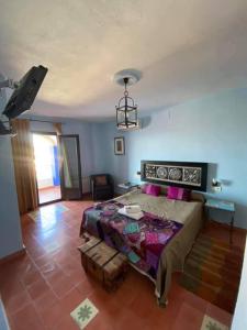 um quarto com uma cama grande e uma sala de estar em Hotel Rural La Posada de las Cigüeñas em Jerez de los Caballeros