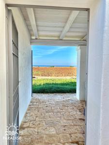 a door to a patio with a view of a field at Paradise Sea Terrace in Monopoli