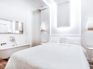 a white bedroom with a bed and a bathtub at Luxury Apartment in the Heart of the City - 1BR in Athens