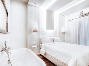 two beds in a white room with a window at Luxury Apartment in the Heart of the City - 1BR in Athens