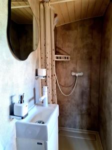 a bathroom with a sink and a mirror at Maringotka KLINGER in Banská Štiavnica